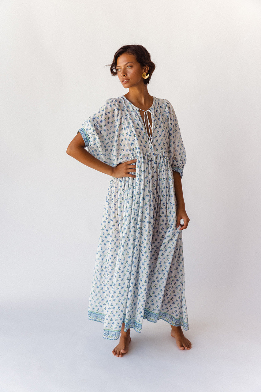 Daughters of India Kyra Maxi Dress in Azure — studio front view hand on hip, V-neckline tie, gathered waist detail