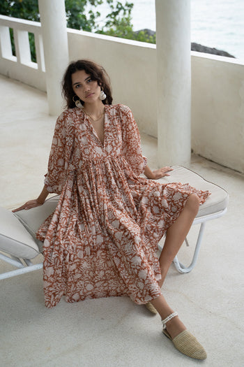 Daughters of India Kyra Midi Dress in Caramel — seated on coastal veranda with ocean view, hand screen print cotton