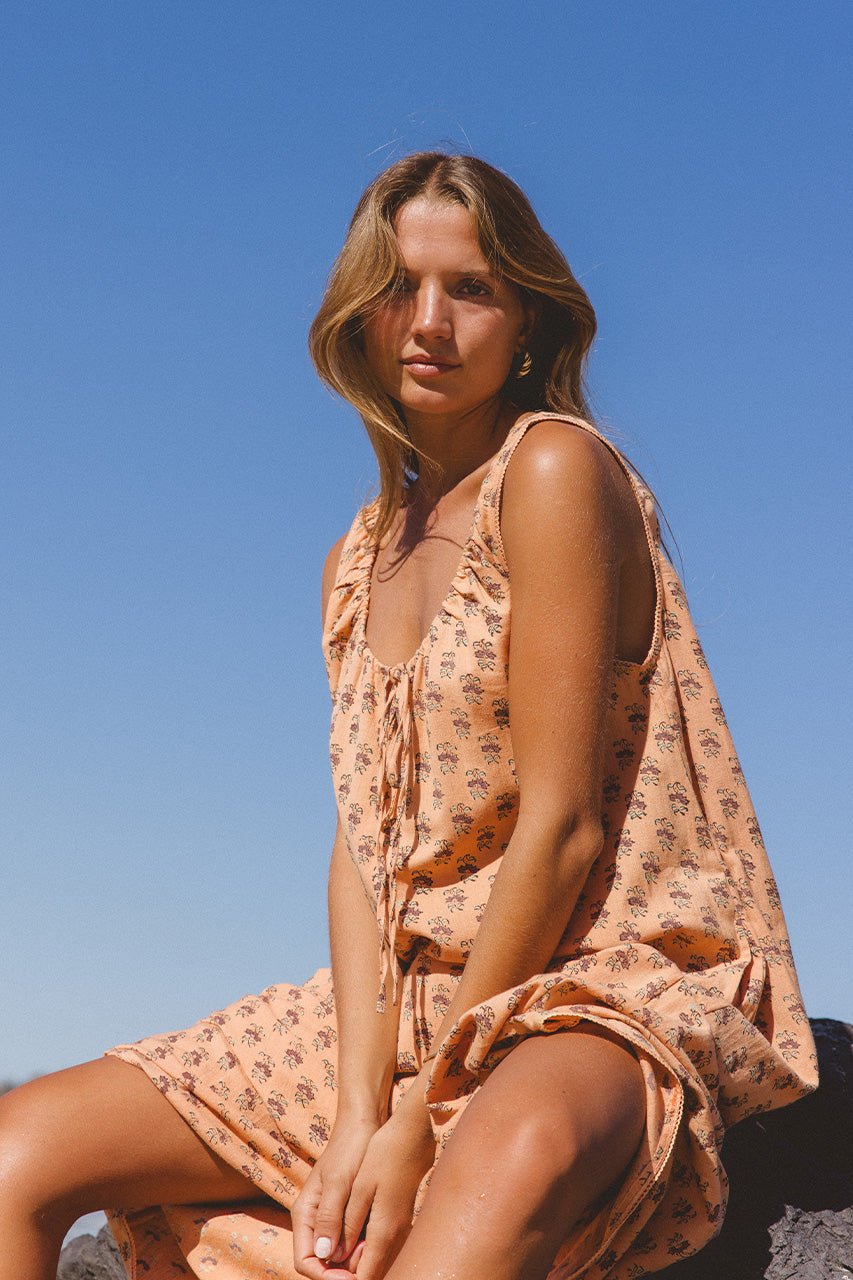 Sundress Midi Peach — studio close-up neckline detail, tie-gather bow at neckline, block print floral motif detail on peach cotton fabric, handcrafted artisan textile, Jaipur India | Daughters of India